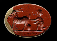 A roman red jasper intaglio set in a modern gold mounting. Shepherd and goat.