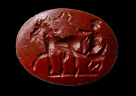 A roman red jasper intaglio. Male figure on his chariot.