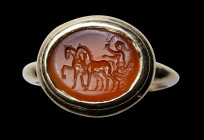 A roman carnelian intaglio mounted in a modern gold ring. Biga.