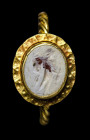 A lombardic gold ring set with a roman burnt agate intaglio. 