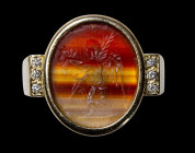 A roman banded agate intaglio mounted on a modern gold ring set with brillants. Winged Victory.