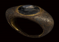 A large late hellenistic gilted bronze ring set with glass paste.