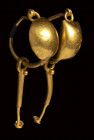 A roman pair of gold earrings with disc and pendants.