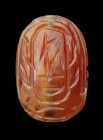 An Egyptian ptolemaic carnelian scarab.