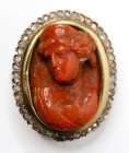 A postclassical coral cameo mounted in a gold broch with brillants. Bust of a woman.