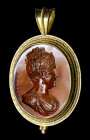 A fine neoclassical carnelian intaglio signed CERBARA, mounted in a gold pendant. Bust of Maria Luisa di Borbone.