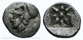 Ionia, Uncertain, 5th century BC. AR Hemiobol (8mm, 0.42g). Head l., with short hair, wearing Corinthian helmet. R/ Star of eight long rays in incuse ...