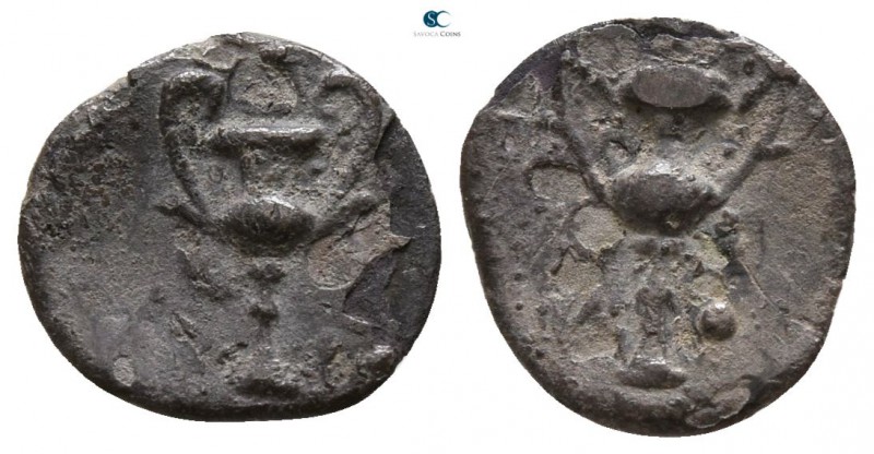 Calabria. Tarentum 280-228 BC.
Obol AR

10mm., 0,36g.

Kantharos; three pel...
