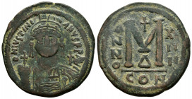 JUSTINIAN I.(527-565).Constantinople.Follis.

Obv : D N IVSTINIANVS P P AVC.
Helmeted, cuirassed bust facing, holding cross on globe and shield with h...
