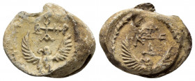 Byzantine lead seal of Arsaveros (?) officer.(7th cent.)

Obverse: Eagle with open wings to left, invocative cruciform monogram over its head resolved...