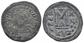 Justinian I. 527-565. Æ Follis. Cyzicus mint, 1st officina. Dated RY 19 (545/6). 
Obv: Helmeted and cuirassed bust facing, holding globus cruciger and...