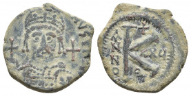 Justinian I Æ 20 Nummi. Theoupolis (Antioch), dated RY 25 = AD 551/2 . 
Obv: [D N IVSTINIANVS P P AVG], helmeted and cuirassed bust facing, holding gl...