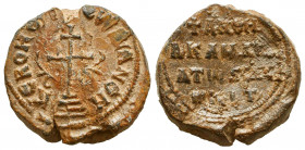 Byzantine lead seal of 
Ivanoes (?) imperial kandidatos and exercitus (?)
(10th cent.)

Obv.: Large patriarchal cross on four steps in the center, cir...