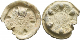 UNCERTAIN, circa 1st-3rd centuries. Votive Dish (Lead, 48 mm, 32.93 g). Radiate facing head of Sol; around, six flowers and six teardrop-shaped incuse...