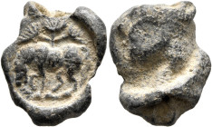 ROMAN. Circa 3rd century. Seal (Lead, 19 mm, 5.58 g). Horse grazing to left; ehind, tree with three branches of foliage. Rev. Textile imprint. Unpubli...