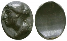 Ancient Greek, Hellenistic HEMATIT ring with portrait of Arsinoe II or Berenike II. Circa 2nd Century BC. with an Oval bezel with relief portrait of q...