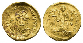 JUSTINIAN I (527-565). GOLD Solidus. Constantinople
Obv: D N IVSTINIANVS P P AVG. Helmeted and cuirassed bust facing, holding globus cruciger and shi...
