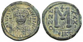 JUSTINIAN I (527-565). Follis. Nicomedia.
Obv: D N IVSTINIANVS P P AVG.
Helmeted and cuirassed facing bust, holding globus cruciger and shield; cros...