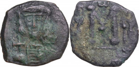 Constantine IV Pogonatus, with Heraclius and Tiberius (668-685). AE Follis, Syracuse mint. Struck 668-674 AD. Obv. Helmeted and cuirassed facing bust,...