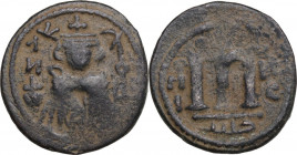 Arab-Byzantine, Umayyad Caliphate. AE Fals, Hims (Emesa) mint, c. 680-693. Obv. Facing imperial bust, holding globus cruciger; KAΛωN to left, bi-hims ...