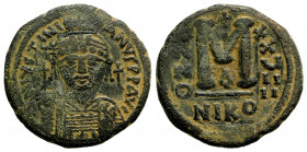 Justinian I. 527-565. AE follis (32 mm, 17.35 g, 6 h). Nicomedia mint, A.D. 555/6. Helmeted and cuirassed bust facing, holding globus cruciger and shi...