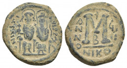 JUSTIN II (565-578). Follis. Nicomedia.
Obv: D N IVSTINVS P P AVC.
Justin, holding globus cruciger, and Sophia, holding cruciform sceptre, seated fa...
