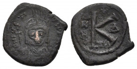 JUSTIN II (565-578). Half Follis. Thessalonica.
Obv: D N IVSTINVS P P AVG.
Helmeted, draped and cuirassed bust facing, holding globus cruciger and s...