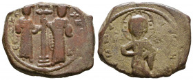 Constantine X. 1059-1067. Æ follis. Christ standing facing on footstool, holding book of Gospels / Eudocia on left and Constantine on right standing f...