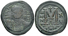 JUSTINIAN I.(527-565).Constantinople.Follis.

Obv : DN IVSTINIANVS PP AVG.
Helmeted, cuirassed bust facing holding cross on globe and shield; cross to...