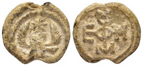 BYZANTINE LEAD SEAL.(Circa 11 th Century).Pb.

Obv : An eagle with its wings outspread. A star above. Wreath border.

Rev : Cruciform invocative monog...