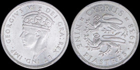 CYPRUS: 9 Piastres (1938) in silver (0,925) with crowned head of King George VI facing left. Two stylized rampant lions, date at right, denomination b...