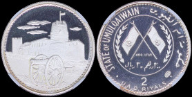 UMM AL QAIWAIN / UAE: 2 Riyals (AH1389 // 1970) in silver (1,000) with dates within crossed flags and sprigs at left and right within circle. Fort of ...