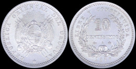 URUGUAY: 10 Centesimos (1877 A) in silver (0,900) with flagged Arms within sprigs, star below and radiant face above. Value within wreath on reverse. ...