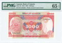 UGANDA: 1000 Shillings (1986) in red and multicolor with Arms at left. S/N: "H/14 941297". WMK: Crane head. Inside holder by PMG "Gem Uncirculated 65 ...
