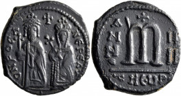 Phocas, 602-610. Follis (Bronze, 27 mm, 9.77 g, 6 h), with Leontia, Theoupolis (Antiochia), RY 4 = 605/6. O N FOCA NЄ PЄ AV Phocas standing facing, ho...