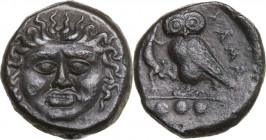 Sicily. Kamarina. AE Tetras or Trionkion, c. 420-410 BC. Obv. Gorgoneion facing, tongue slightly protruding. Rev. KAMA. Owl standing left, head facing...