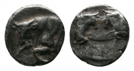 Caria, Uncertain mint. Milesian tetartemorion c.387-377, AR (6mm-0,38g). Confronted foreparts of two bulls. / Forepart of bull left, head turned to fr...