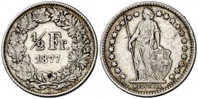 1877. Suiza. B (Berna). 1/2 franco. (Kr. 23). 2,49 g. AG. Pequeño intento de perforación en reverso. Escasa. (MBC).