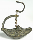 OBJEKTE AUS BRONZE. 
GEFÄSSE. 
Öllampen. Öllampe, byzantinische Bronze-Hängelampe, ovale Form, auf dem Spiegel Büste mit langem breiten Bart in Glor...