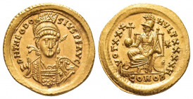 THEODOSIUS II (402-450 AD). GOLD Solidus, Constantinople.
Obv: D N THEODOSIVS P F AVG.
Helmeted and cuirassed bust facing slightly right, holding sp...