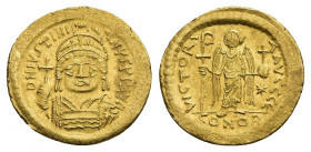 JUSTINIAN I (527-565 AD). GOLD Solidus, Constantinople.
Obv: D N IVSTINIANVS P P AVG.
Helmeted and cuirassed bust facing, holding globus cruciger an...