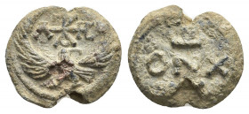 PB Byzantine lead seal (6th-9th century).
Obv: An eagle with its wings outspread. Above, a cruciform monogram.
Rev: Inscription in three? lines.
Co...