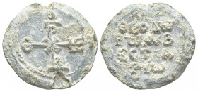 PB Byzantine lead seal. Theodore protovestiarios (7th-8th century).
Obv: Cruciform invocative monogram (type XIV): Χριστὲ βοήθει. Wreath border.
Rev...