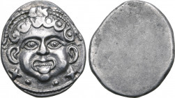 Etruria, Populonia AR 20 Asses. Circa 300-250 BC. Facing head of Metus with curly hair and winged torque-like diadem over head; X X (mark of value) be...