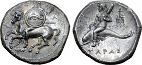 Calabria, Tarentum AR Nomos. Circa 290-281 BC. Warrior wearing crested helmet, holding two spears in right hand and shield adorned with dolphin on lef...