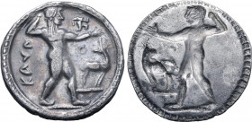Bruttium, Kaulonia AR Stater. Circa 525-500 BC. Nude Apollo walking to right, holding laurel branch in upright right hand, small daimon running to rig...