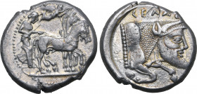 Sicily, Gela AR Tetradrachm. Circa 480-470 BC. Charioteer, holding kentron and reins, driving slow quadriga to right; Nike flying to right above, crow...