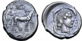 Sicily, Syracuse AR Tetradrachm. Second Democracy, circa 460-450 BC. Charioteer, holding kentron and reins, driving slow quadriga to right; above, Nik...