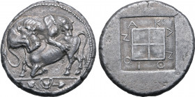 Macedon, Akanthos AR Tetradrachm. Circa 470-430 BC. Lion to right with head three-quarters facing, leaping upon and attacking bull to left; kantharos ...