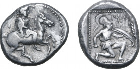 Cilicia, Tarsos AR Stater. Circa 410-385 BC. Persian satrap on horseback to right, wearing kyrbasia; fly behind / Hoplite kneeling to right, holding s...